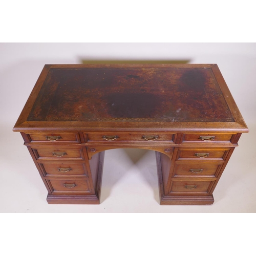 1097 - A fine quality solid walnut kneehole desk with inset gilt tooled leather top stamped Howard & So... 