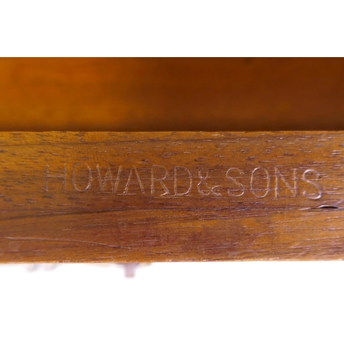 1097 - A fine quality solid walnut kneehole desk with inset gilt tooled leather top stamped Howard & So... 