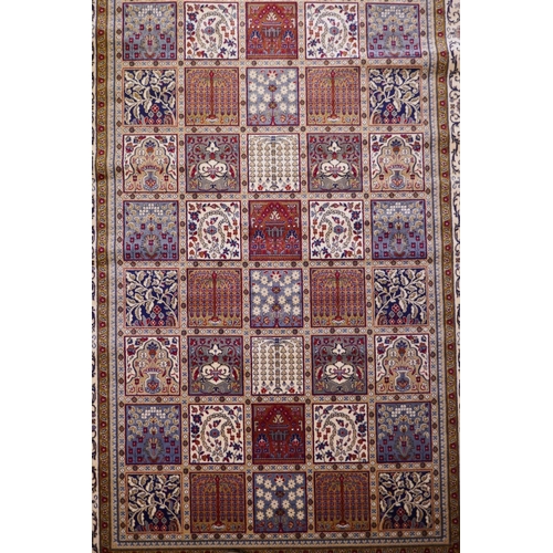 1098 - A full pile ivory ground Kashmir carpet with a Persian panel design, 156 x 230cm