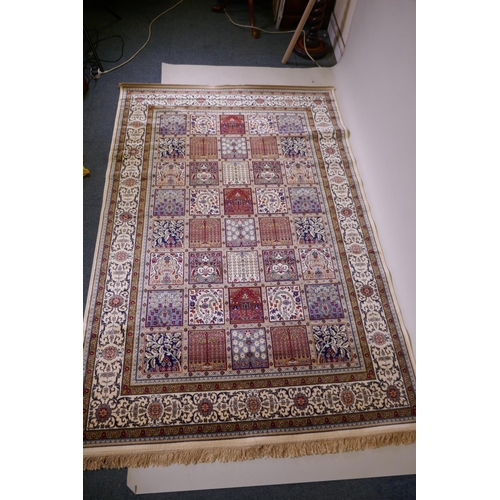 1098 - A full pile ivory ground Kashmir carpet with a Persian panel design, 156 x 230cm