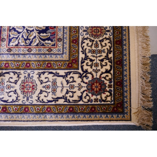 1098 - A full pile ivory ground Kashmir carpet with a Persian panel design, 156 x 230cm