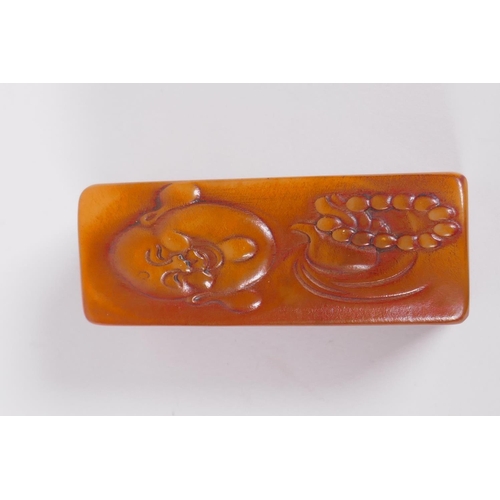 110 - A Chinese soapstone box containing an amber style soapstone seal, the cover with carved Buddha decor... 