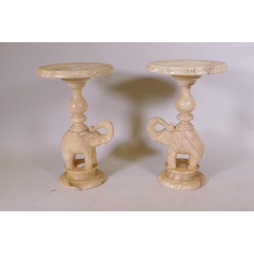 1102 - A pair of alabaster side tables in the form of elephants, 38cm diameter, 62cm high