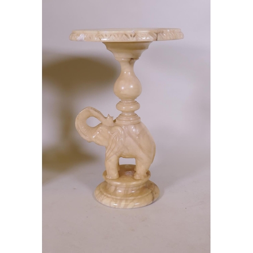 1102 - A pair of alabaster side tables in the form of elephants, 38cm diameter, 62cm high