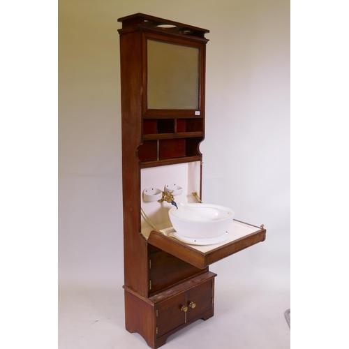 1103 - A mahogany ship's cabin wash stand cabinet, the reservoir behind the mirror, with fall front and fol... 