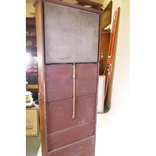 1103 - A mahogany ship's cabin wash stand cabinet, the reservoir behind the mirror, with fall front and fol... 