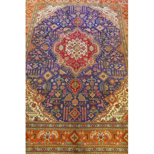 1122 - Large Persian carpet on a rich blue ground and multicolour field, with burnt orange border, Tabriz, ... 