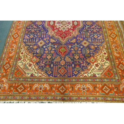 1122 - Large Persian carpet on a rich blue ground and multicolour field, with burnt orange border, Tabriz, ... 