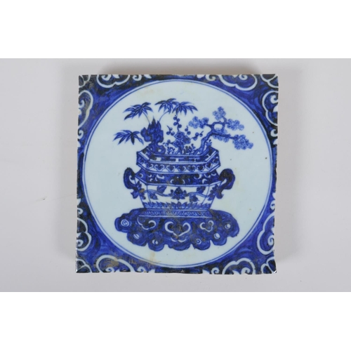 116 - A Chinese blue and white porcelain temple tile decorated with a planter filled with asiatic flora, 2... 