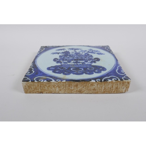 116 - A Chinese blue and white porcelain temple tile decorated with a planter filled with asiatic flora, 2... 