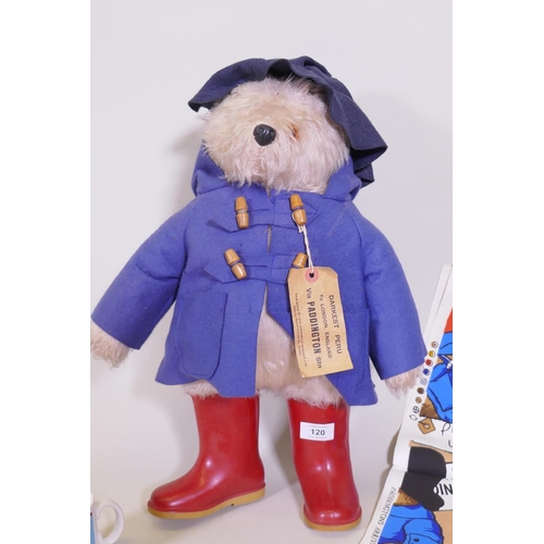 120 - A Paddington Bear by Gabrielle designs, AF tatty coat, two aprons and a mug, and five Paddington's A... 