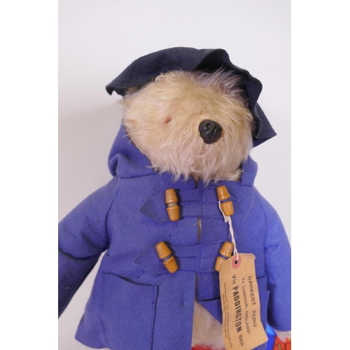 120 - A Paddington Bear by Gabrielle designs, AF tatty coat, two aprons and a mug, and five Paddington's A... 