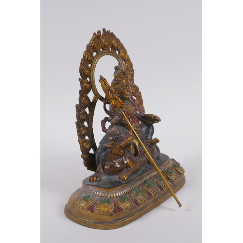 121 - A Sino Tibetan painted bronze figure of a deity seated on a mythical creature, 4 character mark to b... 