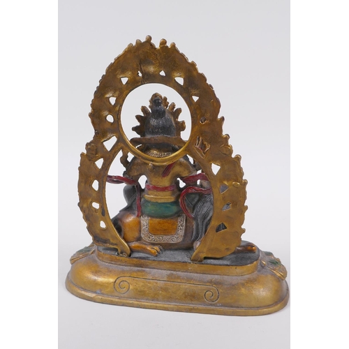 121 - A Sino Tibetan painted bronze figure of a deity seated on a mythical creature, 4 character mark to b... 