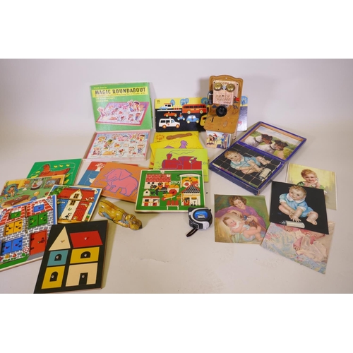 122 - Early C20th block puzzle, a Codec ranch phone money box, jigsaws etc from the 1970s, Disney tin toy ... 