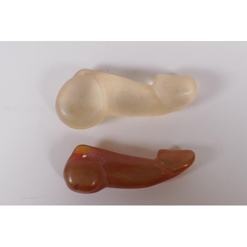 125 - A carved agate phallic pendant and another, 8cm long