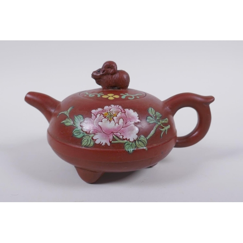 128 - A Chinese Yi Xing teapot on tripod supports with famille rose enamel floral decoration, impressed se... 