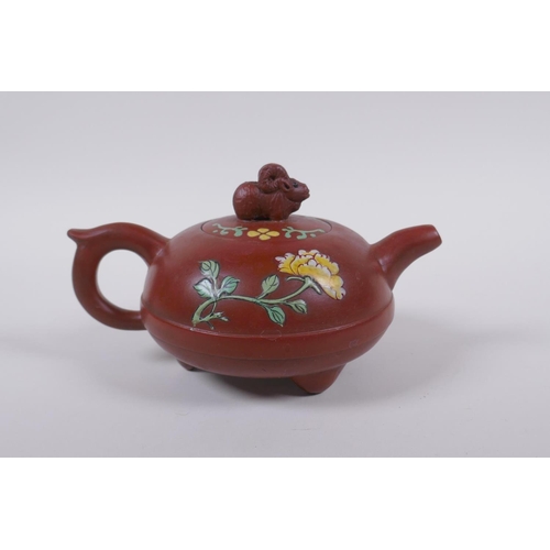 128 - A Chinese Yi Xing teapot on tripod supports with famille rose enamel floral decoration, impressed se... 