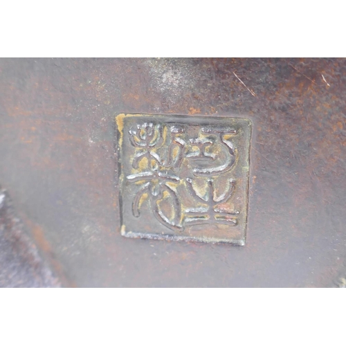 130 - A Chinese bronze censer and cover with a ribbed body and tripod supports, impressed seal mark to bas... 