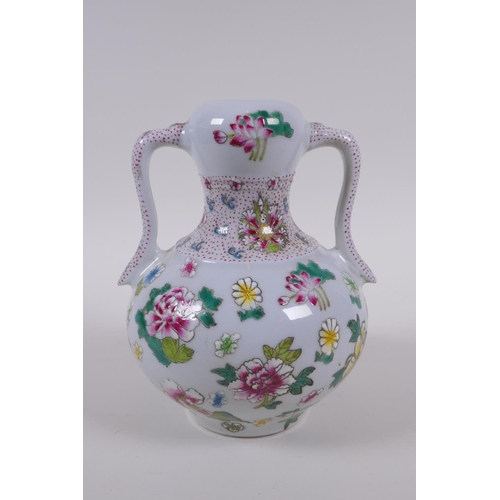 133 - A garlic head shaped porcelain two handled vase, with famille rose enamel floral decoration, Chinese... 