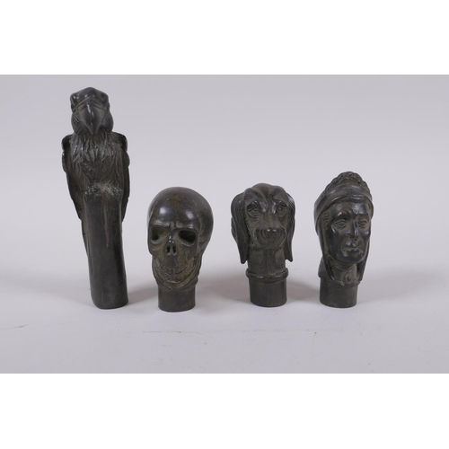 139 - Four bronze walking stick handles in the form of a skull, dog head, head bust and a parrot, largest ... 