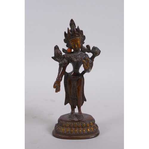 156 - An Indian bronze figure of a standing female deity, 16cm high