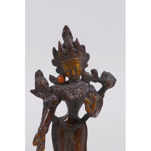 156 - An Indian bronze figure of a standing female deity, 16cm high