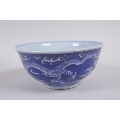 158 - A Chinese blue and white porcelain rice bowl with dragon decoration, Kangxi 6 character mark to base... 