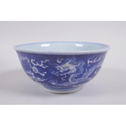 158 - A Chinese blue and white porcelain rice bowl with dragon decoration, Kangxi 6 character mark to base... 