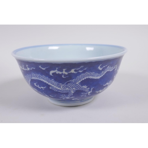 158 - A Chinese blue and white porcelain rice bowl with dragon decoration, Kangxi 6 character mark to base... 