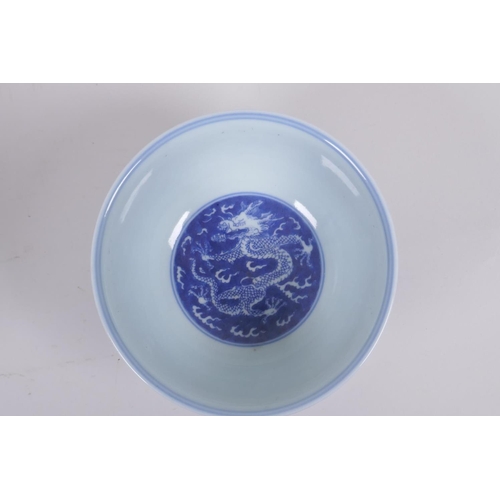 158 - A Chinese blue and white porcelain rice bowl with dragon decoration, Kangxi 6 character mark to base... 