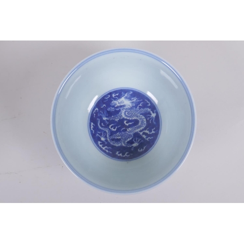 158 - A Chinese blue and white porcelain rice bowl with dragon decoration, Kangxi 6 character mark to base... 