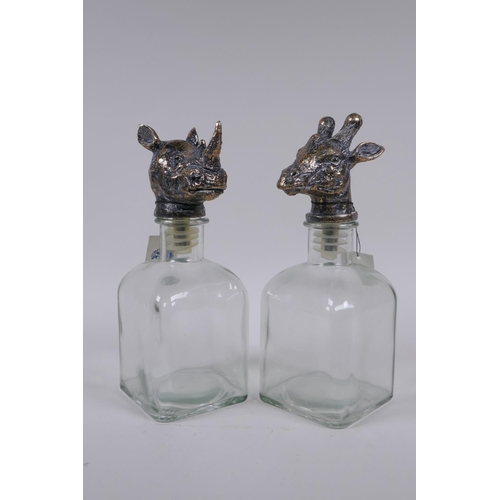 162 - A pair of glass decanters with gilt composition stoppers in the form of animal heads, 25cm high