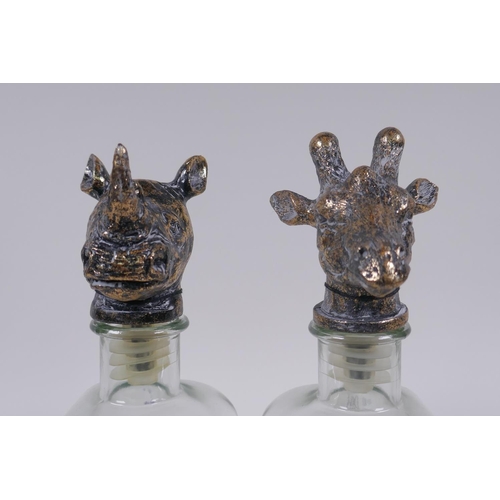 162 - A pair of glass decanters with gilt composition stoppers in the form of animal heads, 25cm high