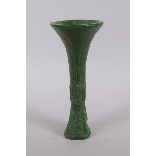 165 - A Chinese reconstituted green hardstone gu shaped vase with archaic decoration, 21cm high