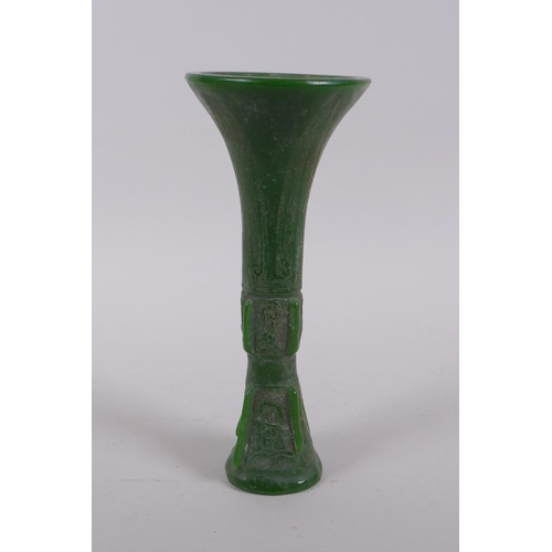 165 - A Chinese reconstituted green hardstone gu shaped vase with archaic decoration, 21cm high