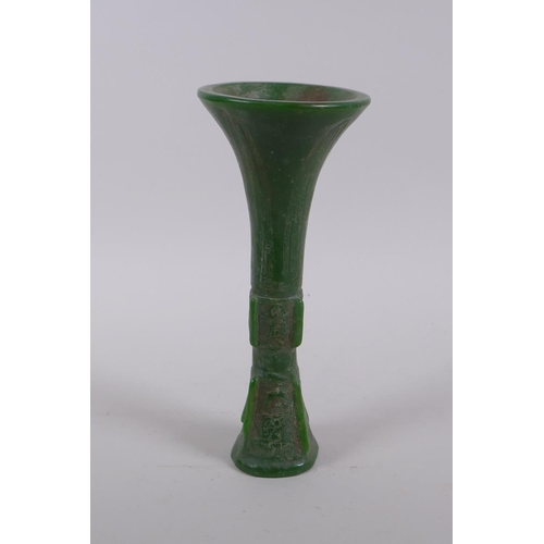 165 - A Chinese reconstituted green hardstone gu shaped vase with archaic decoration, 21cm high