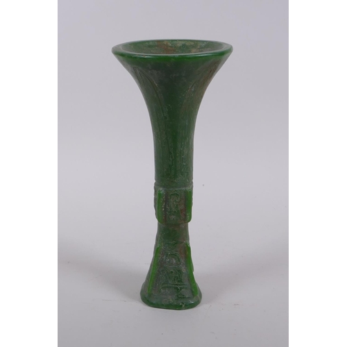 165 - A Chinese reconstituted green hardstone gu shaped vase with archaic decoration, 21cm high