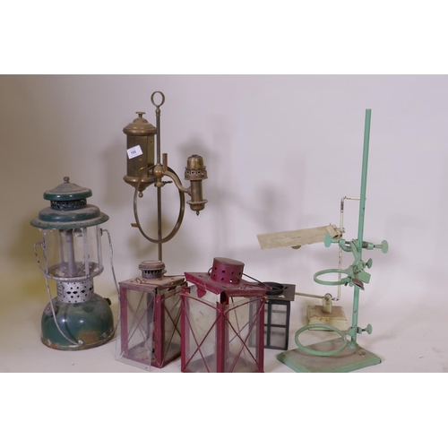 166 - An Akrom pressurised spirit lamp, a brass lamp, garden lanterns AF, and laboratory stands