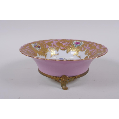 169 - A continental Sevres style pink ground porcelain dish with floral decoration, gilt highlights and br... 