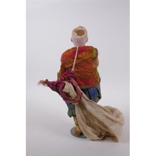 174 - An antique bisque headed doll in Arabian clothing, marked to the back of the neck C10/0, 30cm high