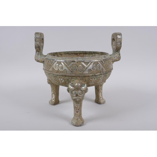 178 - A Chinese archaic style metal censer with two handles, tripod supports and silvered metal decoration... 