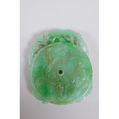 180 - A Chinese carved mottled green jade pendant decorated with flowers, a gourd , kylin and pi disc, 7 x... 