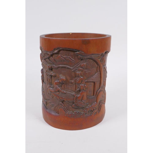 181 - A Chinese carved bamboo brush pot decorated with figures playing go, 16cm high