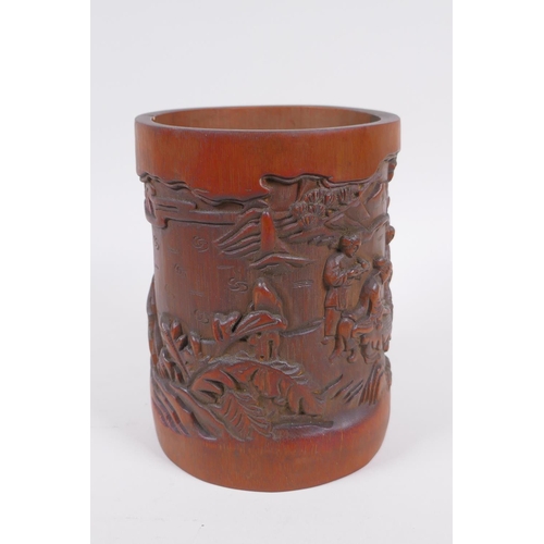 181 - A Chinese carved bamboo brush pot decorated with figures playing go, 16cm high