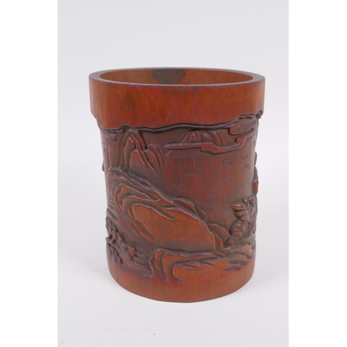 181 - A Chinese carved bamboo brush pot decorated with figures playing go, 16cm high