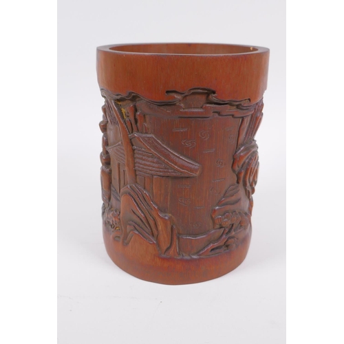 181 - A Chinese carved bamboo brush pot decorated with figures playing go, 16cm high