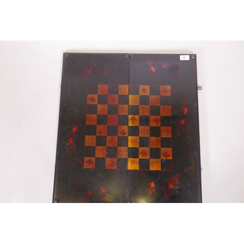 187 - An oriental lacquered fold out games board with chequerboard and backgammon, with painted and gilded... 