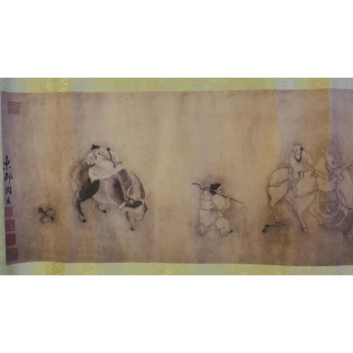 190 - A Chinese printed watercolour scroll depicting figures in a landscape, 220cm x 26cm long