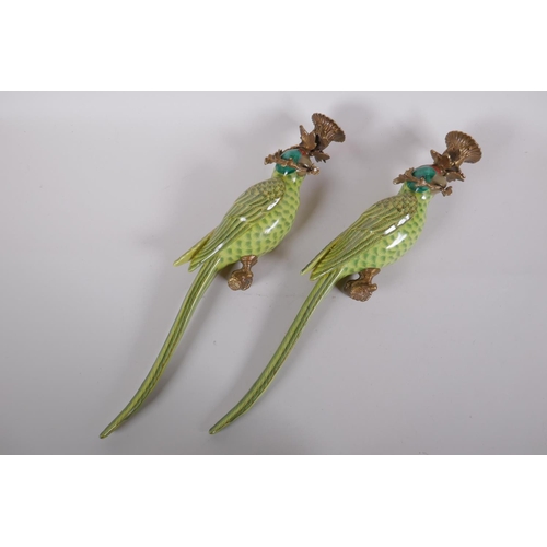 197 - A pair of polychrome porcelain parrot candle sconces with gilt metal mounts, 48cm